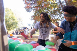 Students play whack-a-mole during a fall festival event