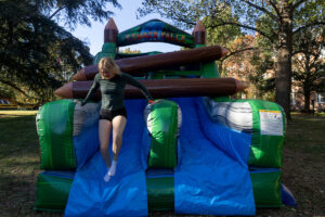A student completes an inflatable obstacle course