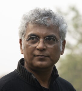 A close-up photo of a man wearing glasses