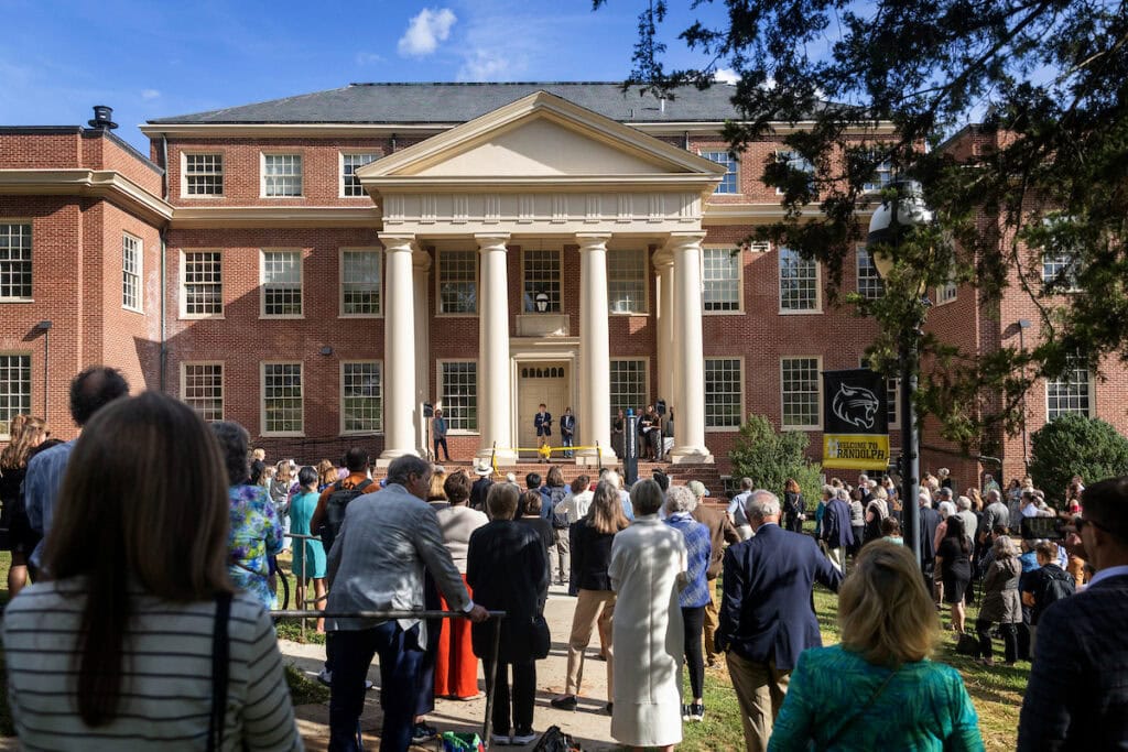 A crowd of people standing outside of a building.