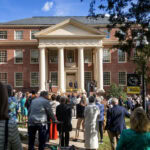 A crowd of people standing outside of a building.