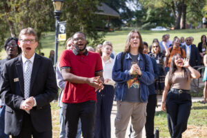 A group of people in a crowd cheer