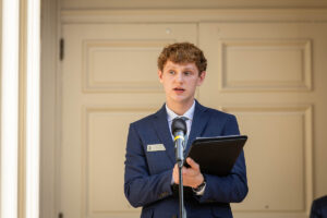 A student stands in front of a microphone during an event