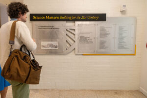 A list of donors is displayed on a wall 