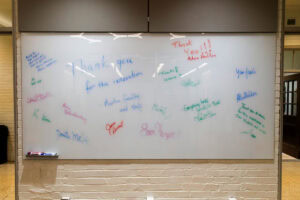 Messages are written on a whiteboard, thanking donors for their support