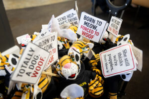A wagon full of mini Wandas, with signs joking about them not being dogs 