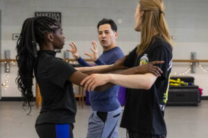 Students practice a dance move during a tango class