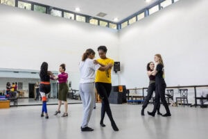 Students practice a dance move during a tango class
