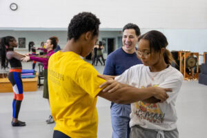 Students practice a dance move during a tango class
