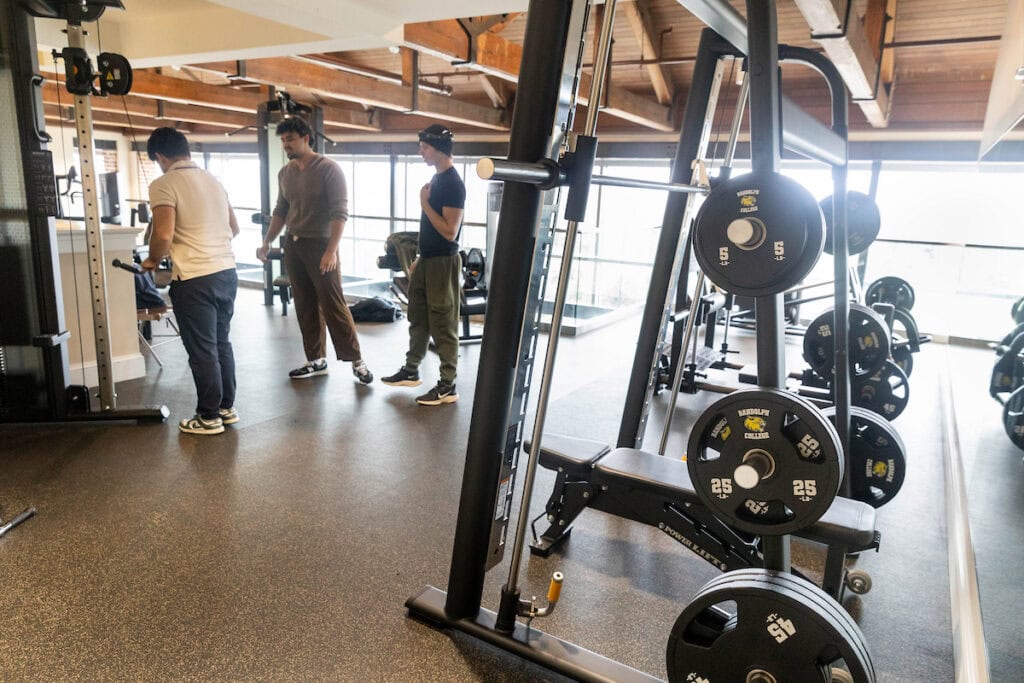 Students look at equipment in the fitness center