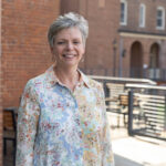 Melissa Merrill ’89 poses for a portrait outside on the Hampson Commons deck Melissa Merrill ’89 poses for a portrait outside on the Hampson Commons deck
