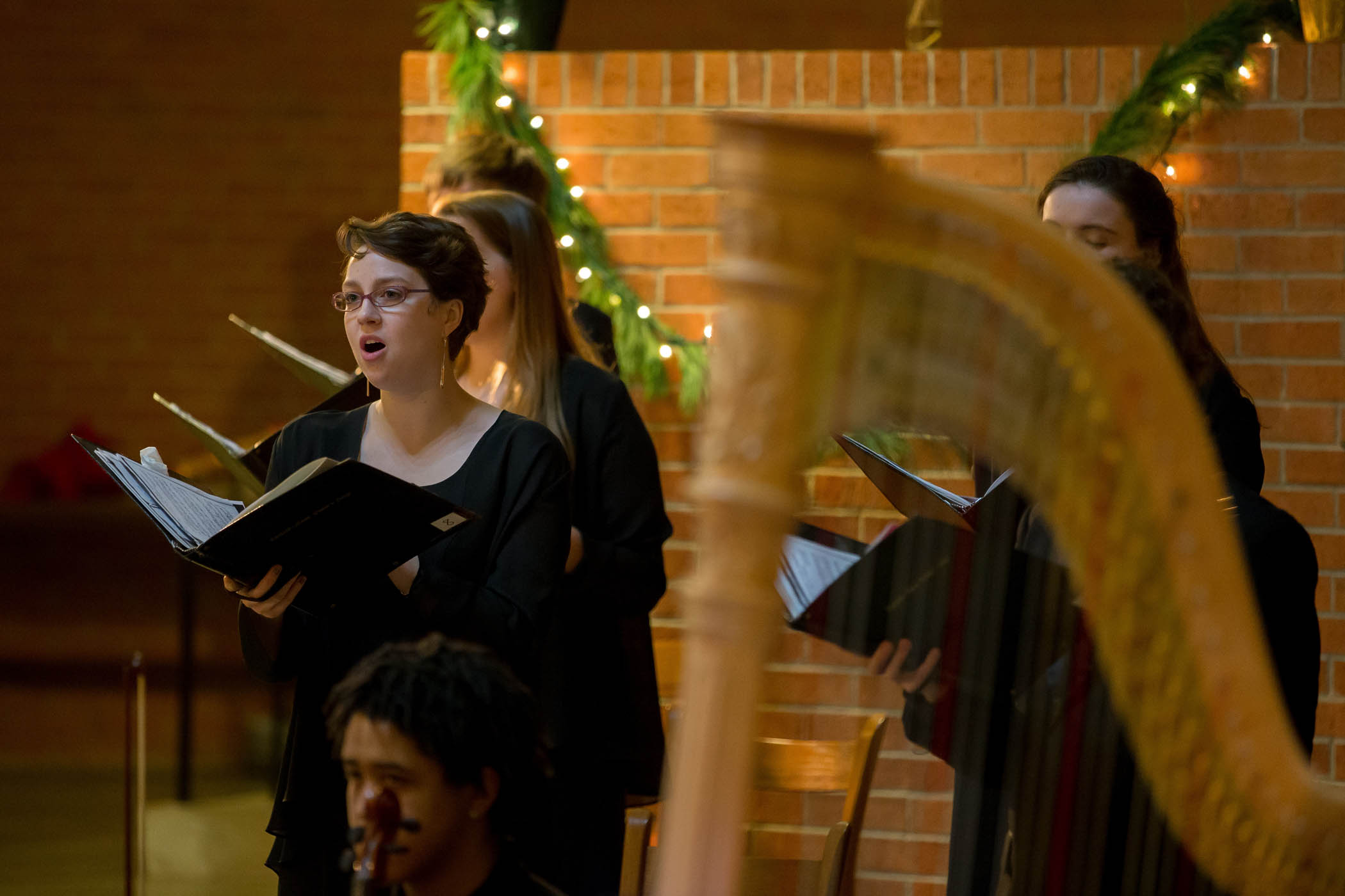 choral singer with a harp in the foreground