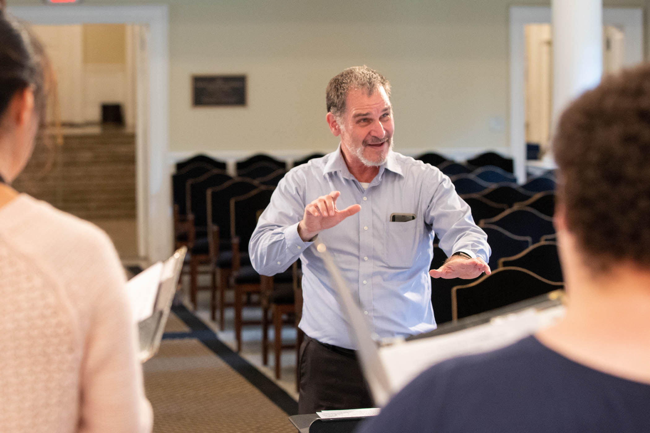 Professor Randall Speer conducts in rehearsal.