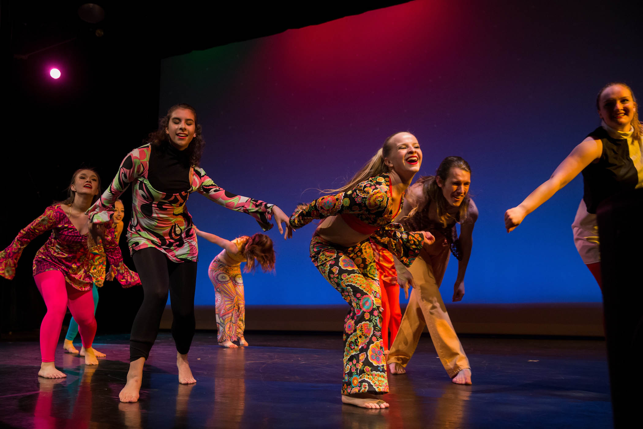 Dancers in colorful costumes perform