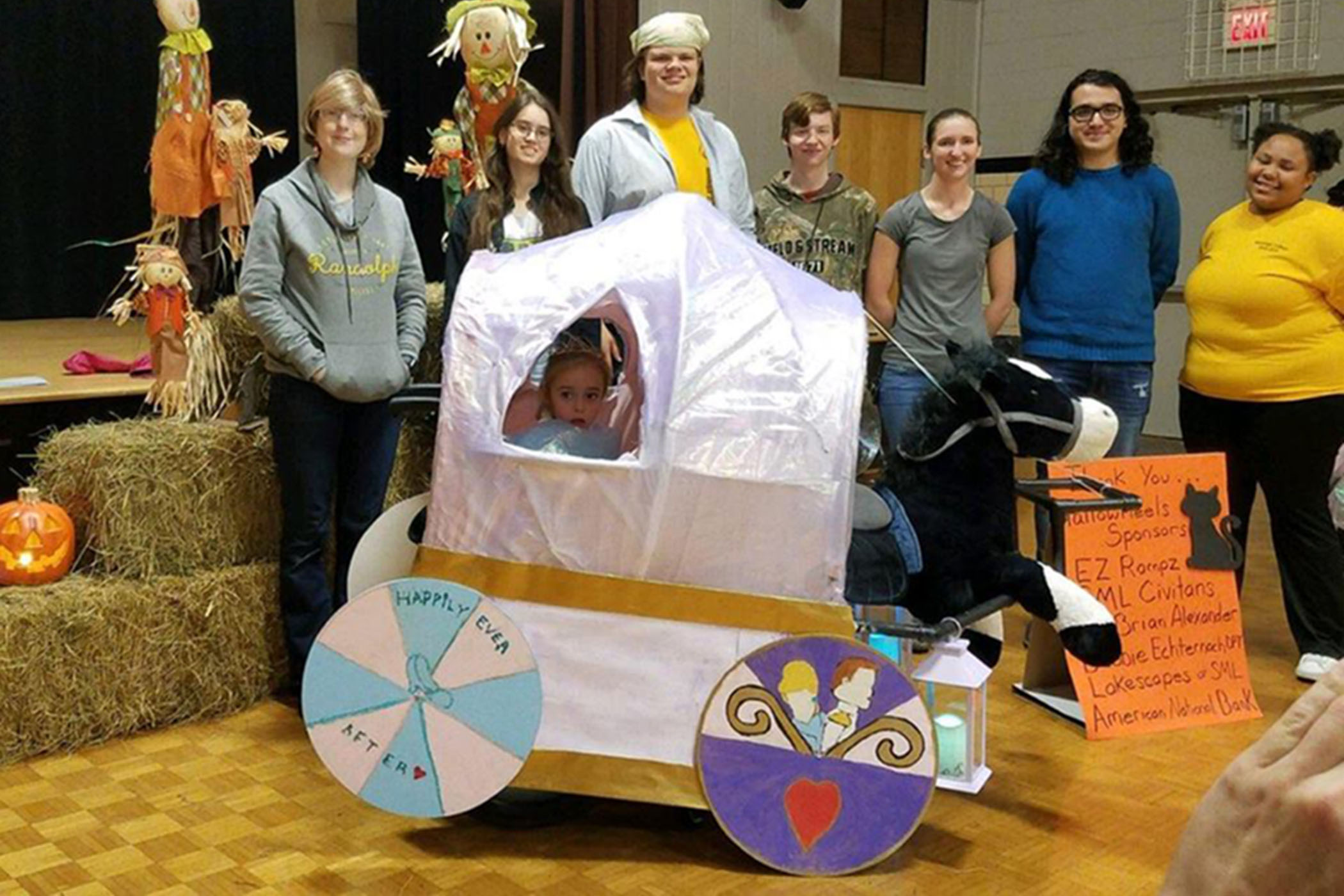 Randolpk College students create a Cinderella themed wheelchair halloween costume for a local girl.