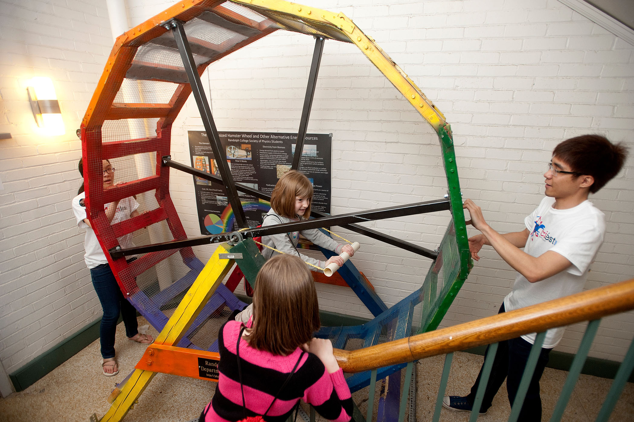 Randolph physics students demonstrate the Human Sized Hamster Wheel to local children during SciFest.