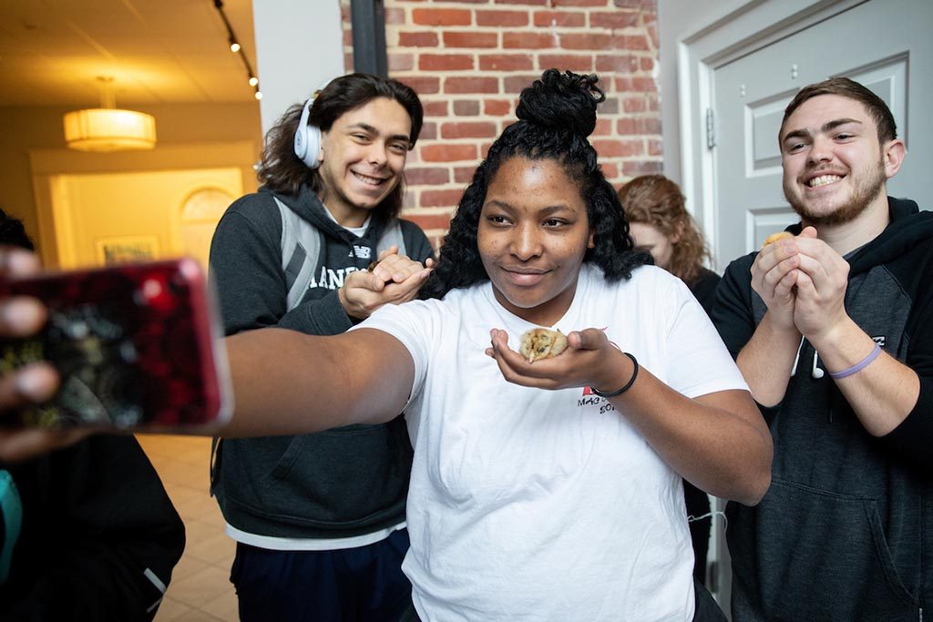 Randolph College students welcome baby chicks who will soon reside in the Organic Garden.