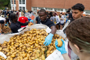 Abundance in Action: New students pack thousands of pounds of potatoes for those in need